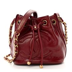 This is an authentic CHANEL Shiny Aged Calfskin CC Chain Mini Drawstring Bag in Red. This super chic bucket is crafted of glazed aged calfskin leather in red. The bag features a leather-threaded gold strap and a leather cinch-cord pull. The top opens to a red fabric interior with a patch pocket. Red Evening Bucket Bag With Dust Bag Included, Luxury Red Pouch Bucket Bag, Red Bucket Bag For Evening With Dust Bag, Designer Red Bucket Bag For Formal Occasions, Luxury Red Leather Bucket Bag, Luxury Burgundy Pouch Bag, Luxury Red Bucket Bag For Travel, Mini Drawstring Bag, Red Fabric