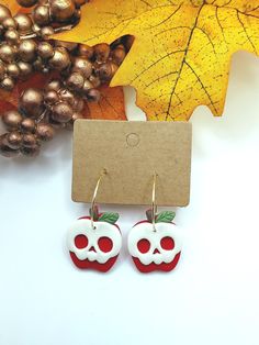 *Handmade Halloween Skull Apple Polymer Clay Earrings | Polymer Clay Earrings | Lightweight | Hypoallergenic | Great Gift for Halloween                                                                                                                                *A perfect gift for any special occasion. Each earring is 100% handmade and made in small batches. Each pair is unique, and cannot be identically replicated. Slight variation may occur between each pair of earrings. Earrings are also assembled with high-quality nickel-free hypoallergenic hardware, which makes it comfortable for sensitive ears as well.   *EARRING CARE:  -Please do NOT wear the earrings in contact with water to prevent damage. -When not wearing, place the earrings in a separate container to prevent the surface from b Red Earrings As Halloween Gift, Red Earrings For Halloween Gift, Handmade Themed Earrings For Gift, Halloween Earrings Diy, Halloween Clay Earrings, Skull Apple, Halloween Clay, Earrings Polymer, Halloween Time