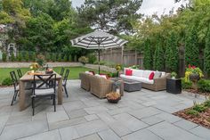 an outdoor living area with patio furniture and umbrella