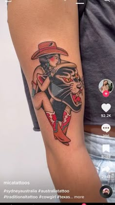 a person with a tattoo on their arm and the image of a cat wearing a hat