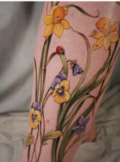 a woman's leg with flowers painted on it