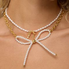 Add a touch of whimsy to your outfit with our Inspired Big Bow Pearl Necklace! Featuring a bold bow pendant, this necklace is perfect for layering and adding a fun twist to your style. A must-have for any fashion-forward individual! Imitation Pearl Beads 48 cm long 18k Gold Plated Over Brass 18K Gold Center Big Bow Extendable Lobster Clasp Adjustable Necklace With Decorative Bow, Chic Ribbon Necklace For Gift, Feminine Bow Necklace For Party, Chic Ribbon Necklace Perfect For Gifts, White Necklace With Butterfly Knot For Gift, Chic Bow Necklace For Gift, Feminine White Jewelry With Bow, Trendy Party Jewelry With Decorative Bow, Pearl Jewelry With Bow Detail