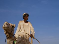 a man riding on the back of a camel