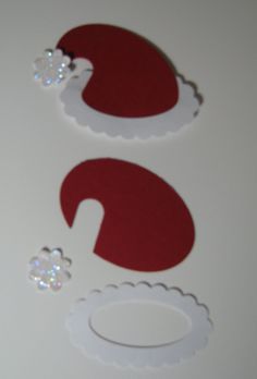 santa hat cutouts and other decorations on a table