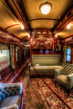 the inside of a train car with couches and chairs