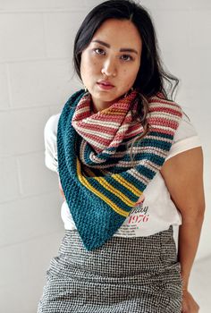 a woman wearing a multicolored knitted scarf