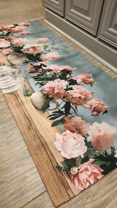 a rug with pink flowers on the floor