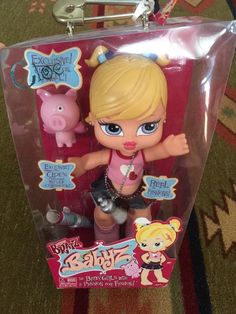 the littlest doll is in its plastic case with her name and character on it