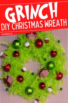 a christmas wreath made out of green tulle and red baubles with the words grin diy christmas wreath on it