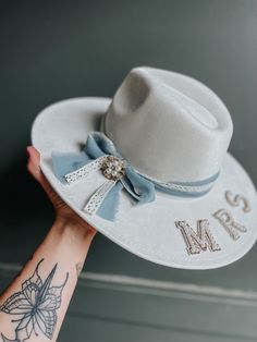 Hat fits head sizes 18"-24" with an adjustable inner headband.  Ribbon and Letters can be customized!  The center brooch may vary due to supplies. Custom Adjustable Wedding Hats, Personalized White Wedding Hat, Personalized Adjustable Hats For Wedding, Customizable White Wedding Hats, Fedora Hat Wedding, Elopement Gift, Headband Ribbon, Mrs White, Country Cowgirl