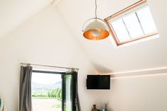 a bed room with a neatly made bed and a flat screen tv