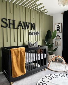 a baby's room with a black crib and green walls