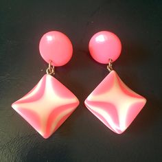 Vintage 80s pink plastic earrings in fantastic new/unworn condition. These pink earrings are made from quality layered plastic in strips of two colours rather like a stick of rock. There is a stud setting on the top section and a dangling moulded square/diamond below. The fittings are stainless steel and in great condition, not worn. They drop to around 4.5 cm when worn. They are fabulous non worn vintage earrings. Funky Pink Jewelry For Party, Trendy Pink Plastic Earrings, Retro Pink Earrings For Party, Pink Plastic Earrings For Party, Retro Pink Party Earrings, Pink Plastic Party Earrings, Pink Retro Earrings For Gift, Stick Of Rock, Disco Earrings