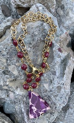 Barse Purple Jasper and Enamel Rosary Bronze Chain Necklace Genuine Purple Jasper Genuine Bronze Lobster Clasp Closure Crafted and Finished By Hand NECK911MUB Approximate Measurements: Length- 16"+ 2" Extender; Pendant Length- 1 1/2" Purple the color of royalty is at the core of this Rosary style necklace. You will feel like a queen when you wear this eye catching necklace. Bronze Chain Necklace, Heart Pendant Necklace Gold, Rosary Style Necklace, Purple Jasper, Flower Statement Necklace, Crystal Heart Pendant, Drop Pendant Necklace, Leather Flowers, Long Pendant Necklace