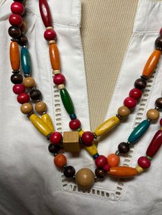 A multi colored necklace made up of mostly wooden beads.  Reminds me of the Aztec culture.  A fun necklace that will brighten up any outfit. Cheap Southwestern Multicolor Necklaces, Fun Multicolor Beaded Necklace With Large Beads, Multicolor Long Beaded Necklaces With Wooden Beads, Multicolor Wooden Beaded Necklaces As Gifts, Multicolor Beaded Long Necklace With Wooden Beads, Multicolor Wooden Beads Necklaces For Gifts, Bohemian Rainbow Beaded Necklaces With Wooden Beads, Multicolor Bohemian Necklace With Wooden Beads, Colorful Wooden Beaded Necklaces For Gifts