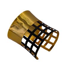 In this design, we've crafted a striking wide-cuffed bracelet adorned with geometric cubes to exude simplicity, style, and harmony. The bracelet features a prominent cuff design with geometric embellishments, creating a captivating dual-tone aesthetic for a seamless look. Crafted with brass as the primary metal, it's plated with 24-karat pure gold and coated with black rhodium for both durability and luxurious appeal. Here are the detailed specifications: Material: Brass main metal plated with 24-karat pure gold Design: Wide cuff adorned with geometric cubes Flexibility: Flexible for comfortable wear Measurements: Bracelet width: 2.76 inches Bracelet length: 6.42 inches This description highlights the intricate craftsmanship and use of premium materials, elevating any outfit with a touch o African Bangles, Square Bracelet, Inspired Bracelets, Bracelet Luxury, Geometric Bracelet, Open Cuff Bracelet, Wide Cuff Bracelets, Wide Bracelet, Group Boards