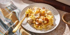 a white plate topped with pasta and chicken