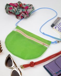 various items are laid out on a table including sunglasses, hair clips and an umbrella