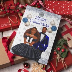 a christmas card with an image of a man and woman on it next to presents