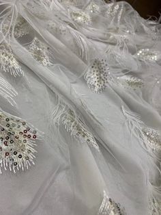 We offer a variety of fashion handmade fabric，those are widely use for wedding dress，garment and fashion cloth. we sell it by yard，our minimum order is 1 yards，and we always package it 15 yards for one roll，the width is 130cm/51 inch Material ： mesh ，Rayon,polyester. Symmetrical embroidery floral pattern, with lovely flowers in the middle, scalloped border. You can also cut and use separately. Perfect for dress, tops, wedding veil. You can split the piece up and have one scalloped edge around th Elegant Embroidered Tulle Fabric For Party, Elegant Sequin Fabric For Wedding And Party Season, Elegant Embroidered Fabric For Summer Party, Glamorous Hand Embellished Sequin Fabric For Wedding, White Sequin Fabric For Wedding And Party Season, Elegant Sequin Fabric For Spring Wedding, Elegant Spring Party Fabric, Elegant Embroidered Organza Fabric For Parties, Elegant Sequined Tulle Fabric For Parties