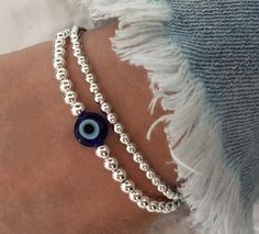 925 Sterling Silver Evil Eye Bracelet 4mm Sterling Silver Round Beads  8mm Blue Evil Eye Bead Stack of 2 includes: one Evil Eye Bracelet one 3mm Plain Bracelet Stack of 3 includes: one Evil Eye Bracelet one 3mm Plain Bracelet one 4mm Plain Bracelet PRICE SHOWN IS FOR 1 BRACELET ONLY* Silver Beaded Bracelets With Evil Eye, Silver Spiritual Evil Eye Bracelet With Round Beads, Silver Evil Eye Bracelet With 8mm Beads As Gift, Silver Evil Eye Bracelet With Round Beads For Gift, Silver Evil Eye Bracelet With Round Beads, Blue Sterling Silver Bracelet With Round Beads As Gift, Bracelets Evil Eye, Stacked Bracelets, Bracelet Blue