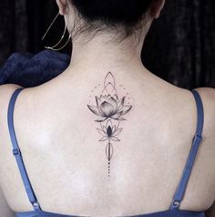 a woman with a lotus tattoo on her back