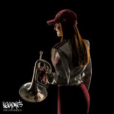 a woman with long hair wearing a baseball cap and holding a trumpet