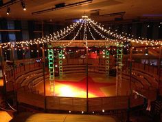 an empty stage with lights on the ceiling and some stairs leading up to the top