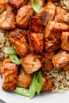 chicken and rice in a white bowl with chopsticks