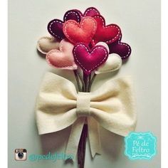 three felt hearts are attached to a bow tie