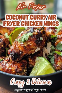 a bowl filled with chicken wings and garnished with cilantro, lime wedges