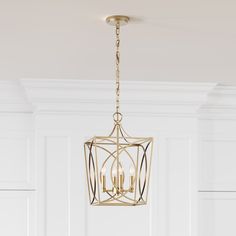 a chandelier hanging from the ceiling in a room with white walls and flooring