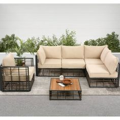 an outdoor furniture set with coffee table and couches