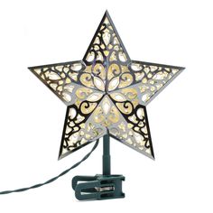 a decorative star shaped light on a white background