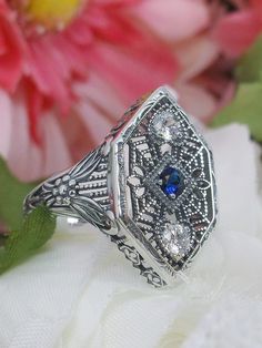 Blue Sapphire Ring, Sterling Silver Filigree, Charlotte design, vintage jewelry, Silver Embrace Jewelry, D231 Antique Silver Sapphire Ring With Diamond Accents, Silver Sapphire Ring With Intricate Design For Formal Occasions, Vintage Silver Filigree Ring With Diamond Accents, Formal Silver Sapphire Ring With Intricate Design, Heirloom Sterling Silver Filigree Ring With Diamond Accents, Art Deco Sterling Silver Filigree Ring With Diamond Cut, Silver Sapphire Filigree Jewelry, Elegant Silver Sapphire Ring With Filigree, Silver Sapphire Jewelry With Filigree