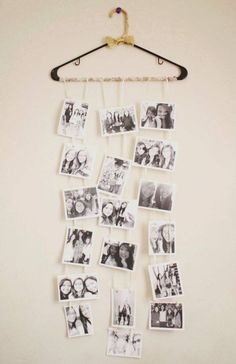 several pictures hanging on a wall with clothes pins attached to the hanger and clips