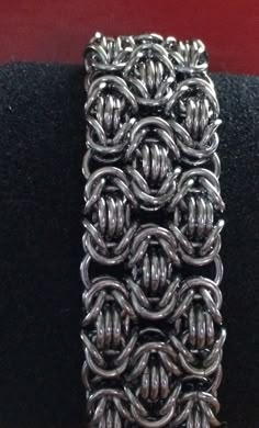 "This handmade chainmaille bracelet is made from heavy stainless steel rings forming the tri- Byzantine chainmaille weave to form a wide cuff bracelet with a sturdy toggle clasp. The bracelet material is slightly heavier than others due to the material that I use but it is very flexible and fluid like and feels fantastic on the wrist. I prefer stainless steel to many other metals because they're sturdy they don't fade and they don't tarnish and they have that oxidized shade instead of being shin Byzantine Chainmaille, Chainmaille Jewelry Patterns, Chain Maille Patterns, Chainmail Patterns, Chainmaille Tutorial, Chainmail Necklace, Chainmail Bracelet, Chainmail Jewelry, Chainmaille Jewelry