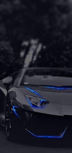 a black sports car with blue lights on it