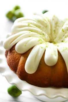 a bundt cake with white icing and green sprinkles