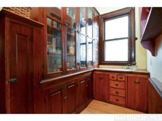 an empty kitchen with wooden cabinets and drawers