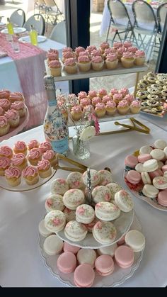 a table topped with lots of cupcakes and cakes