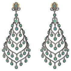 Introducing our Victorian 10.68 Cttw. Emerald and Diamond Chandelier Earrings – a breathtaking blend of elegance, sophistication, and timeless beauty. Crafted with meticulous attention to detail, these chandelier earrings feature an exquisite open-work, neckline drop design encrusted with shimmering round brilliant diamonds. The diamonds, with a total weight of 5.67 carats, sparkle and shine against the backdrop of sterling silver mounting polished with black rhodium, adding a touch of drama and Luxury Green Chandelier Earrings For Festive Occasions, Diamond Chandelier Earrings, Diamond Chandelier, Jewellery Sketches, Drop Design, Black Rhodium, Drops Design, Emerald Diamond, Diamond Clarity