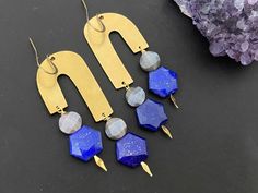 This earring consists of geometric brass findings paired with lapis lazuli and chocolate moonstone stones. The total length of the earrings is around 2.25 inches from the ear lobe. The components here is made of brass . Beautiful gemstones is suspended from the body. Your earrings will come in a box ready for gifting.Let me know if you have any questions. Geometric Brass Earrings For Gift, Minimalist Blue Brass Earrings, Modern Brass Jewelry With Natural Stones, Geometric Ear Wire Earrings For Jewelry Making, Minimalist Brass Earrings With Natural Stones, Blue Brass Earrings With Natural Stones, Nickel-free Geometric Brass Earrings, Blue Earrings With Natural Stones, Handmade Modern Brass Earrings