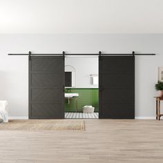 an open door leading to a bathroom with green tiles on the wall and white walls