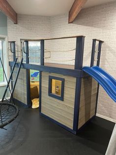 a child's play area with a slide and climbing frame