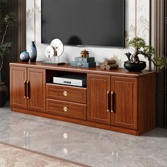 an entertainment center with a flat screen tv mounted on it's side and drawers