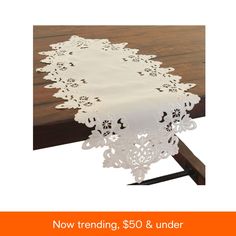 an image of a white table cloth with flowers on it and the words $ 50 & under