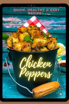 chicken poppers in a black bucket with a red and white checkered napkin next to it