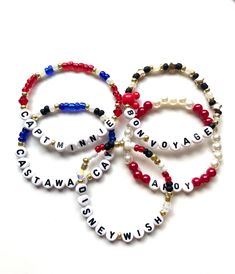 three bracelets with words and beads on them