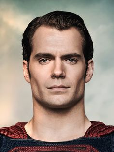 a man in a superman suit with blue eyes